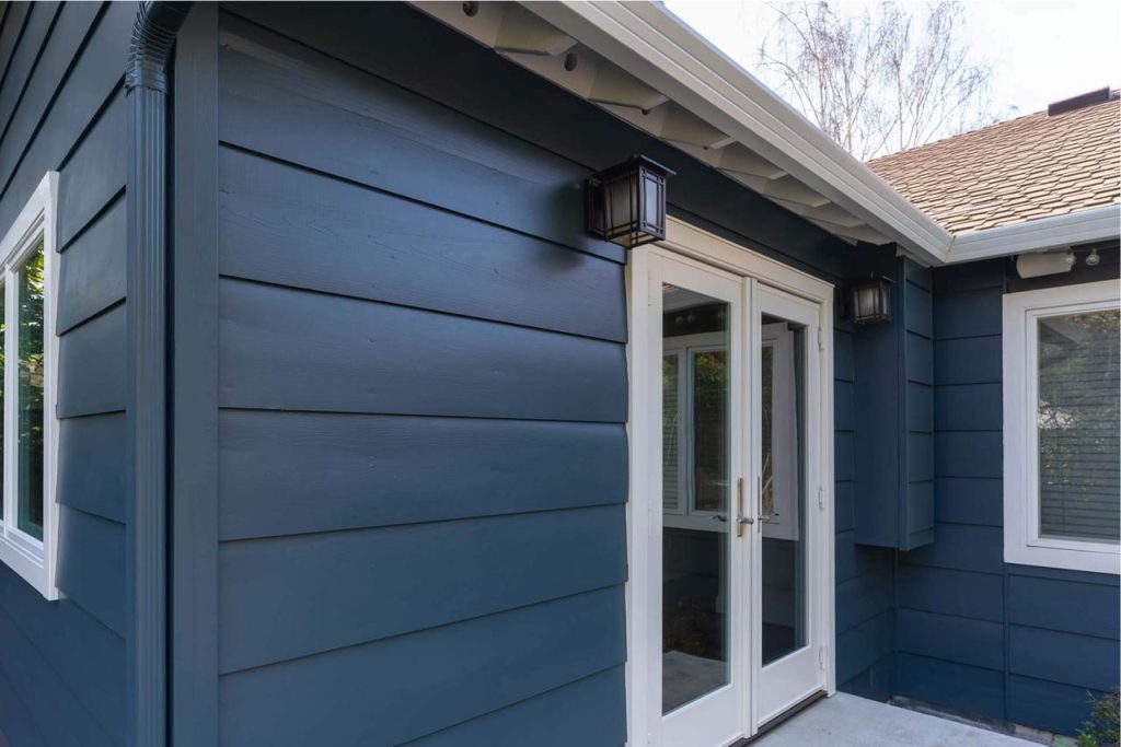 Modern home addition prices Honolulu project showcasing sleek navy blue exterior siding with clean contemporary lines