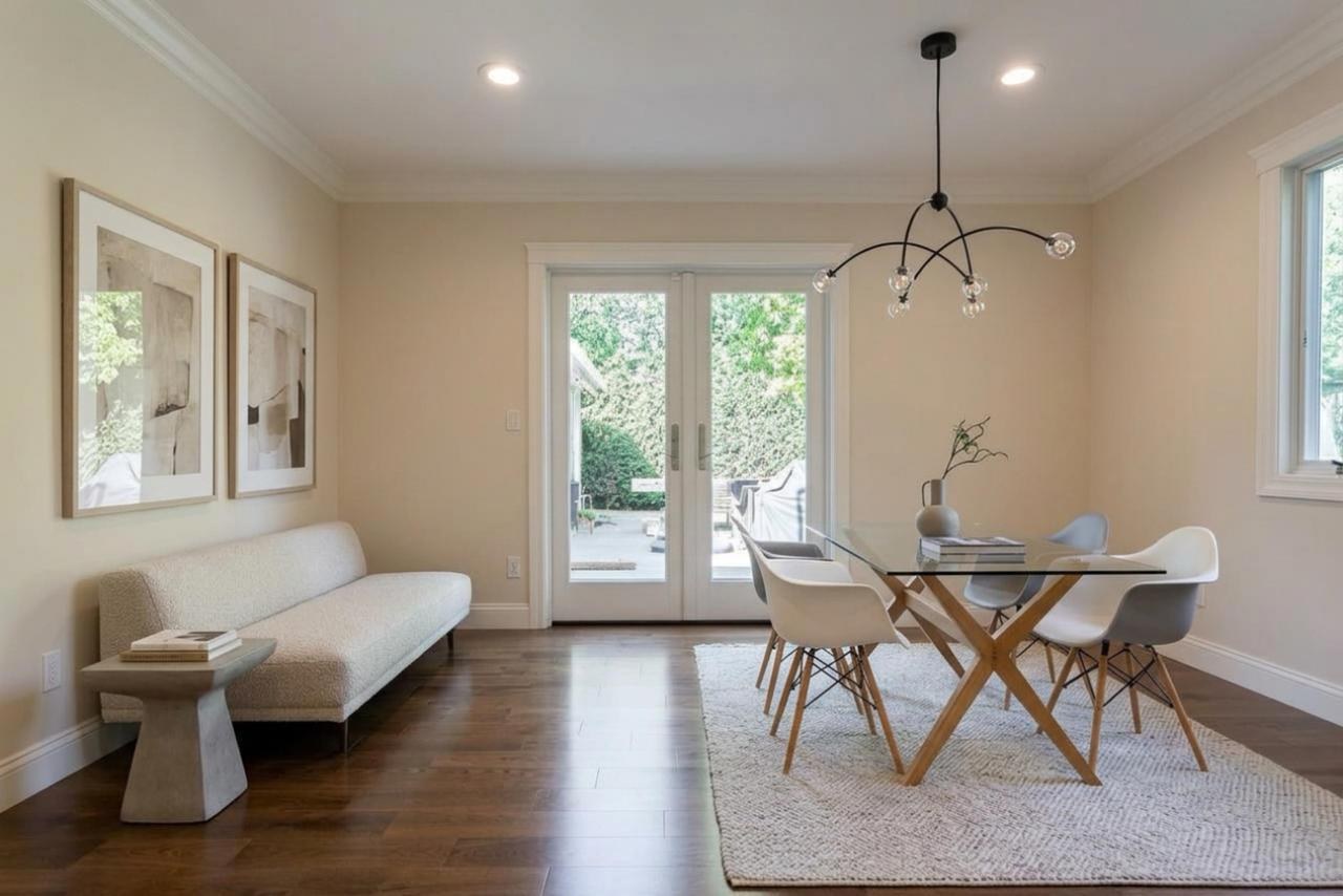 Living room after: French doors opening to backyard patio with hardwood flooring and painted drywall, by ASL Remodeling.