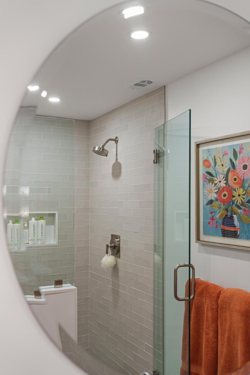 Bathroom after: glass enclosed shower with subway tile with subway tile and frameless glass, by ASL Remodeling.