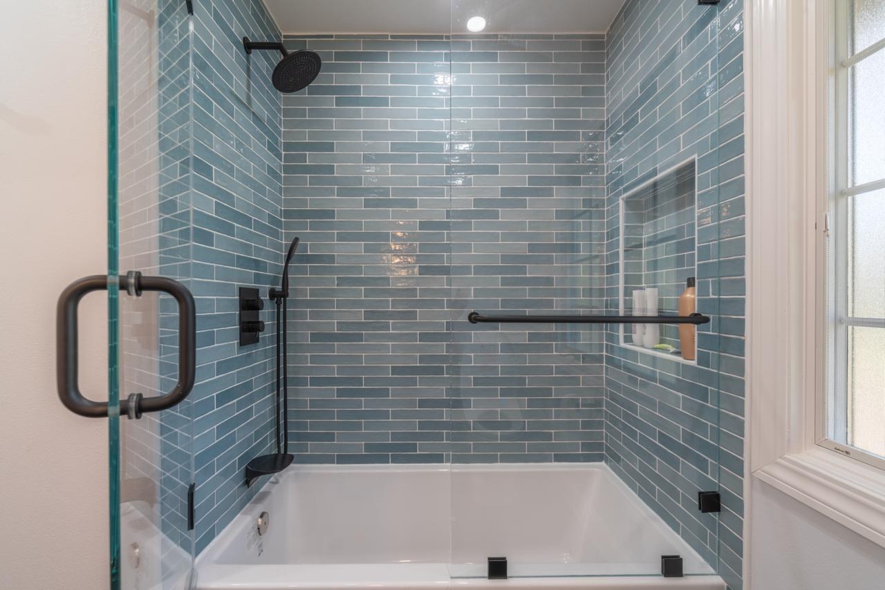 Bathroom: blue glazed subway tile tub shower combo with glazed ceramic subway tile and frameless glass enclosure, by ASL Remodeling.