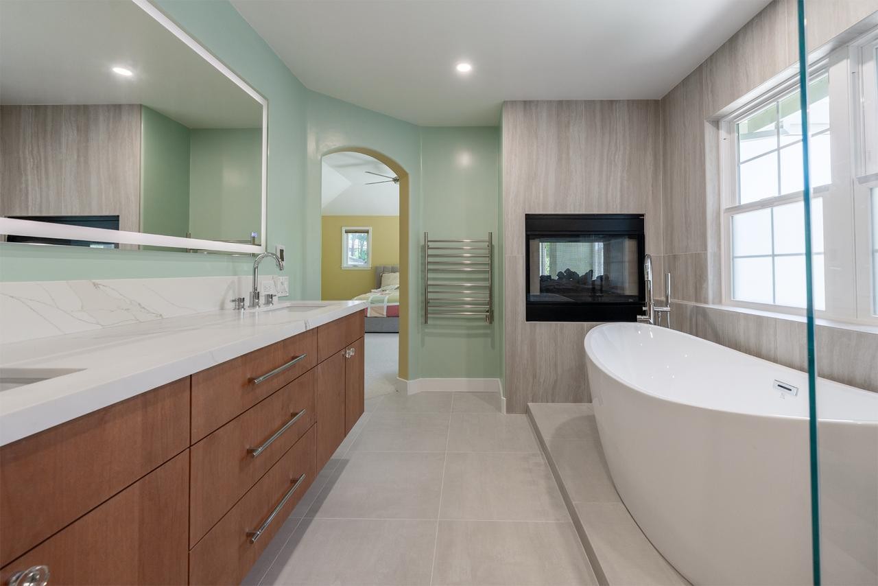 Custom walnut vanity with an LED-integrated mirror and warm lighting