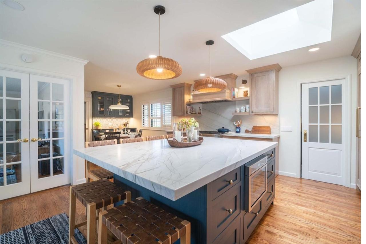 Kitchen remodel with two-tone island, natural quartzite countertops, custom maple cabinetry, and open concept layout