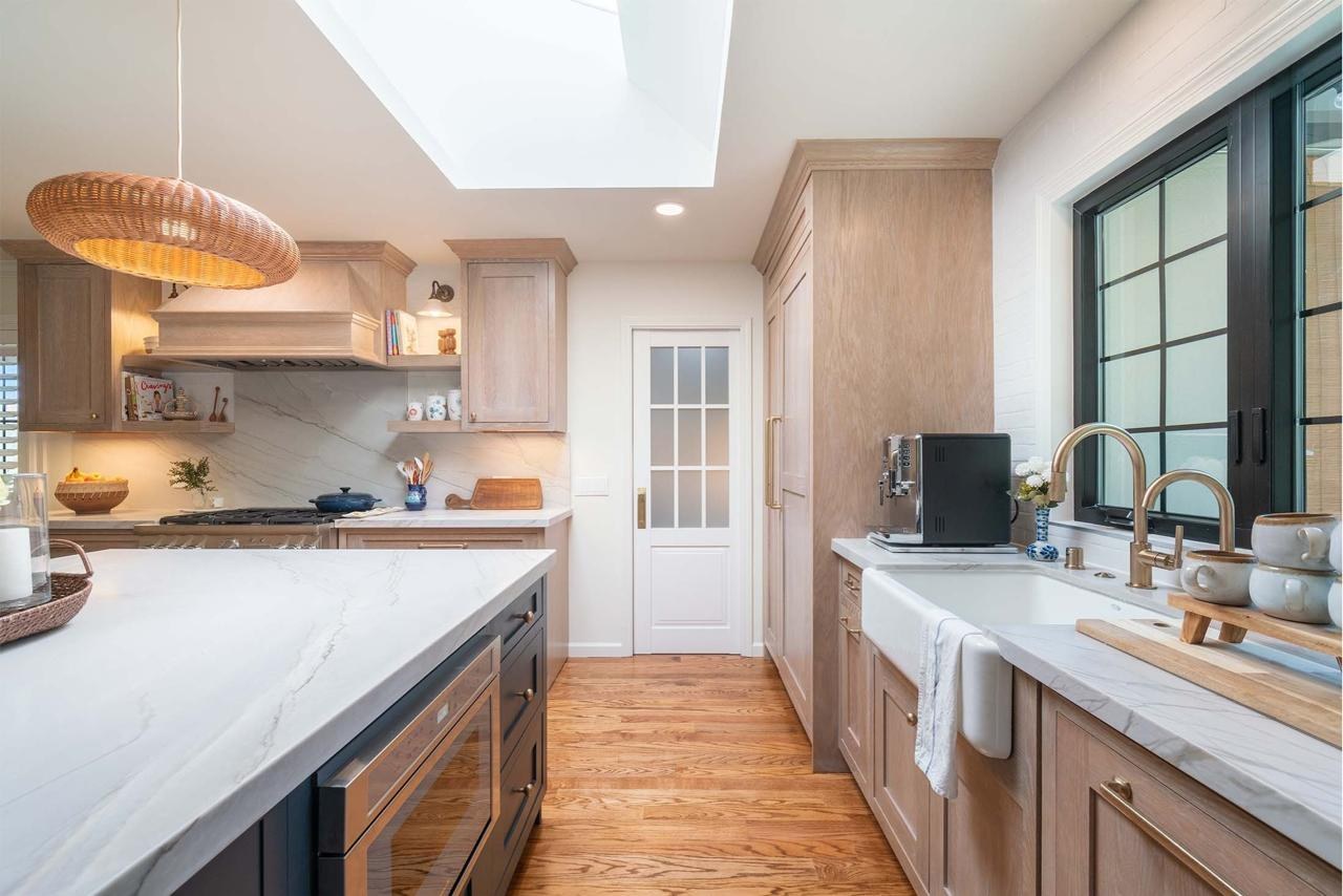Kitchen remodel featuring two-tone maple cabinetry, natural quartzite countertops, and custom walk-in pantry with skylight