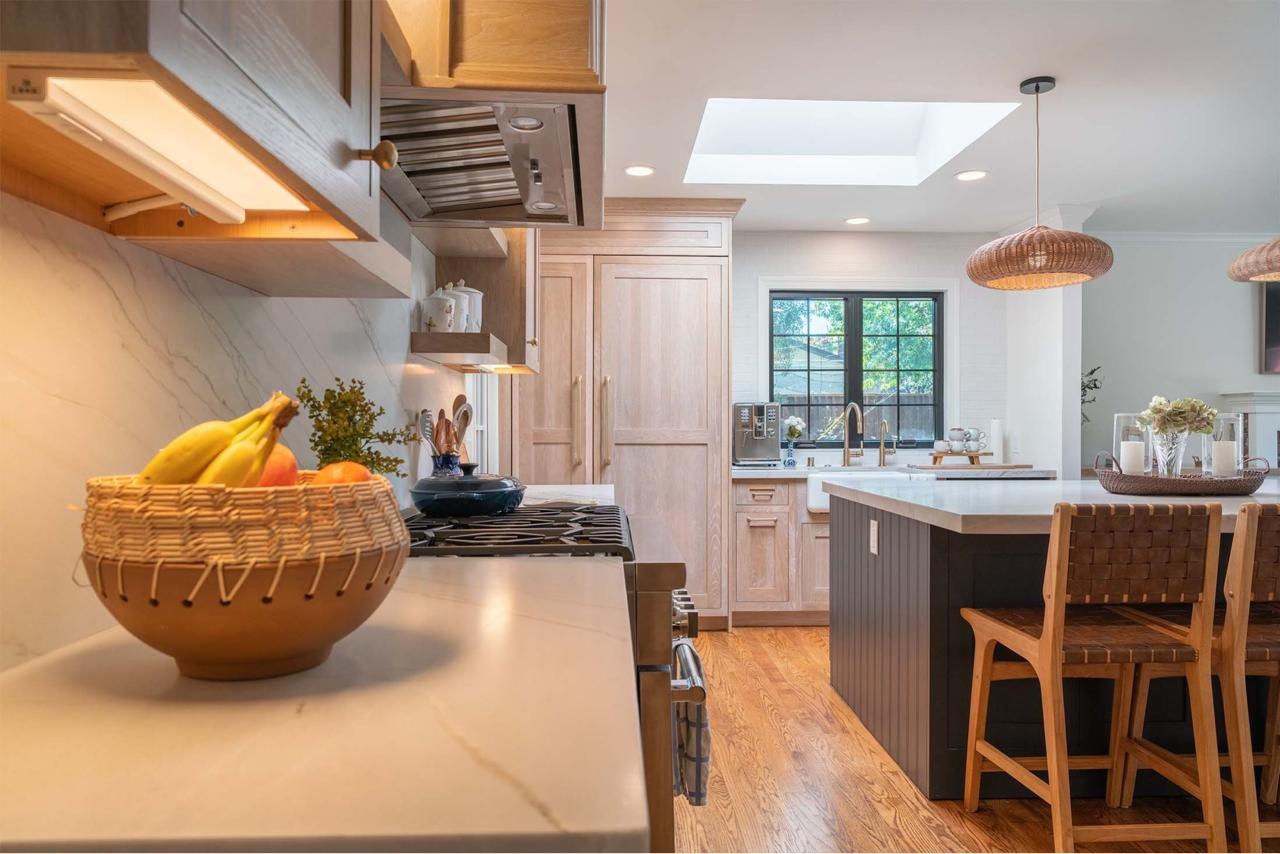 Completed project home remodel showcasing open concept kitchen with skylight, custom maple cabinetry, natural quartzite countertops, and dining flow