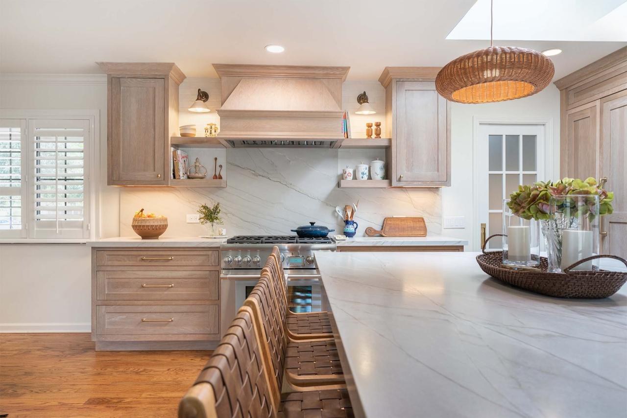 Home remodel kitchen featuring custom maple cabinetry, natural quartzite countertops, floating shelves, and open concept flow to dining area