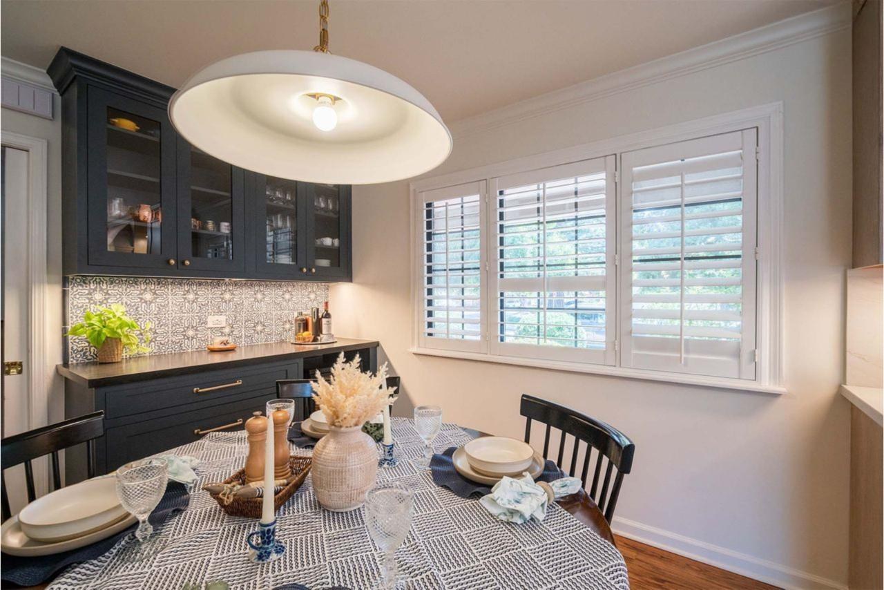 Home transformation kitchen showcasing natural quartzite peninsula, custom cabinetry with soft-close hardware, and contemporary atmosphere