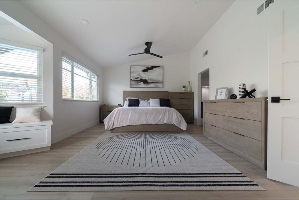 Primary bedroom with white oak hardwood flooring, designer lighting, and modern finishes throughout
