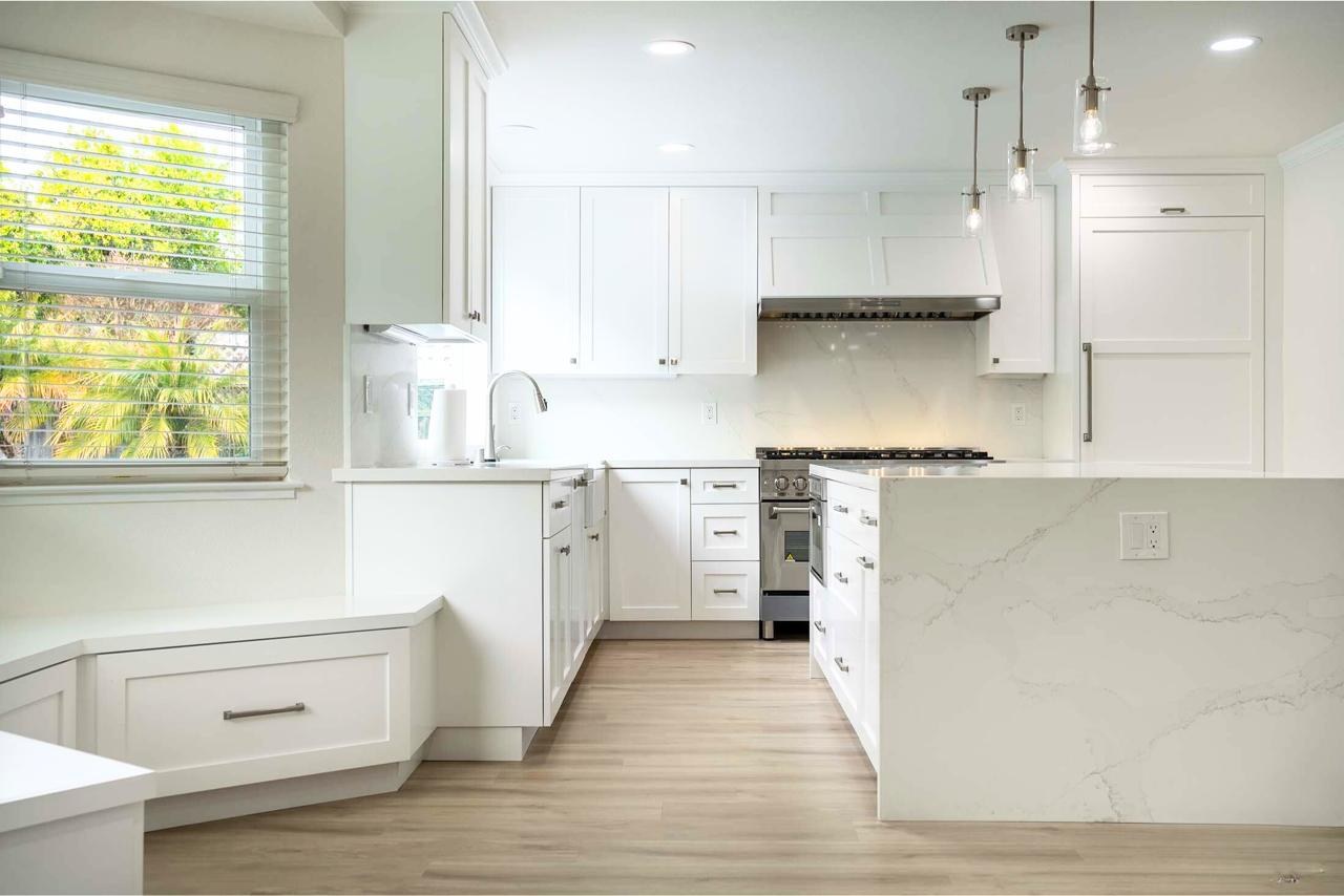 Kitchen remodel featuring custom maple cabinetry, quartzite countertops, and open concept layout with natural light