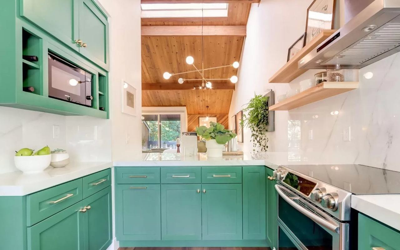 Kitchen featuring custom green maple cabinetry, wood ceiling with skylight, open shelving, and porcelain countertops