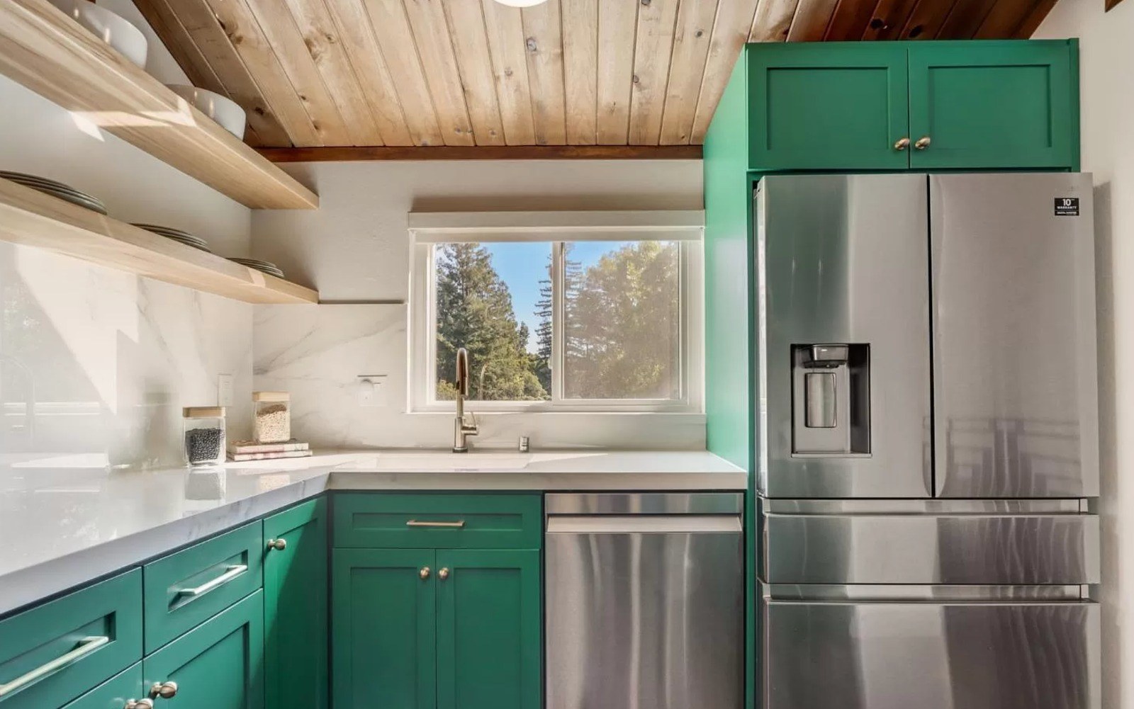 Kitchen with custom green maple cabinetry, wood ceiling with exposed beams, open shelving, and stainless appliances