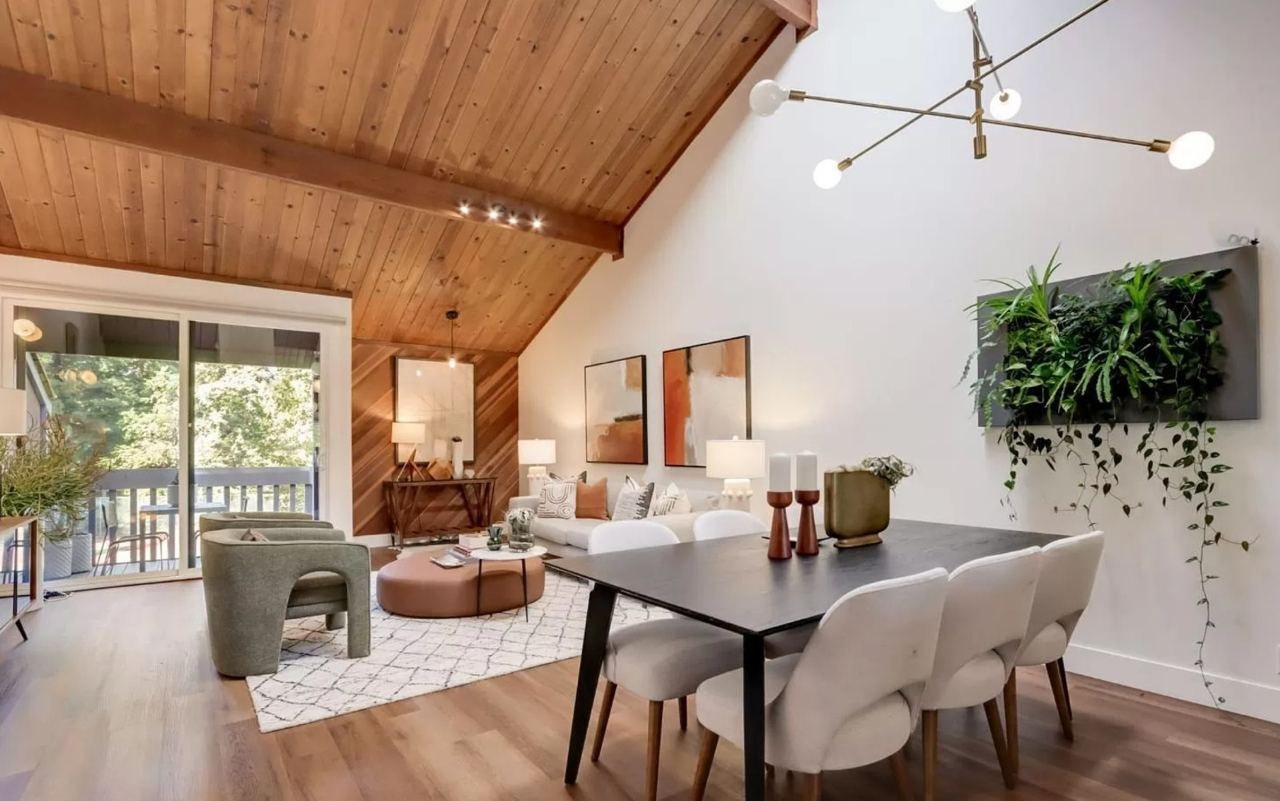 Home featuring open living area with wood ceiling, diagonal wood accent wall, and wide-plank floating vinyl flooring