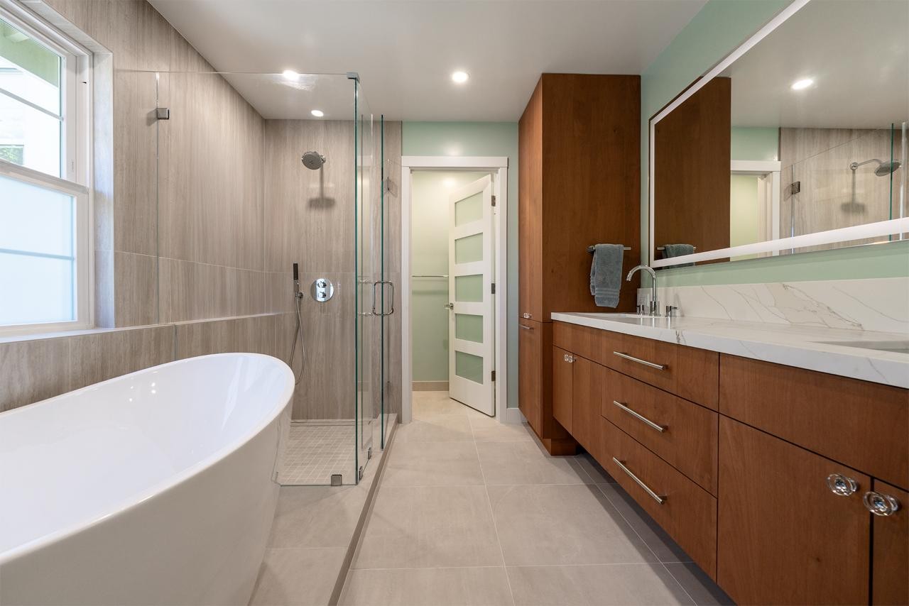 Primary bathroom with custom walnut cabinetry and a spa-style design
