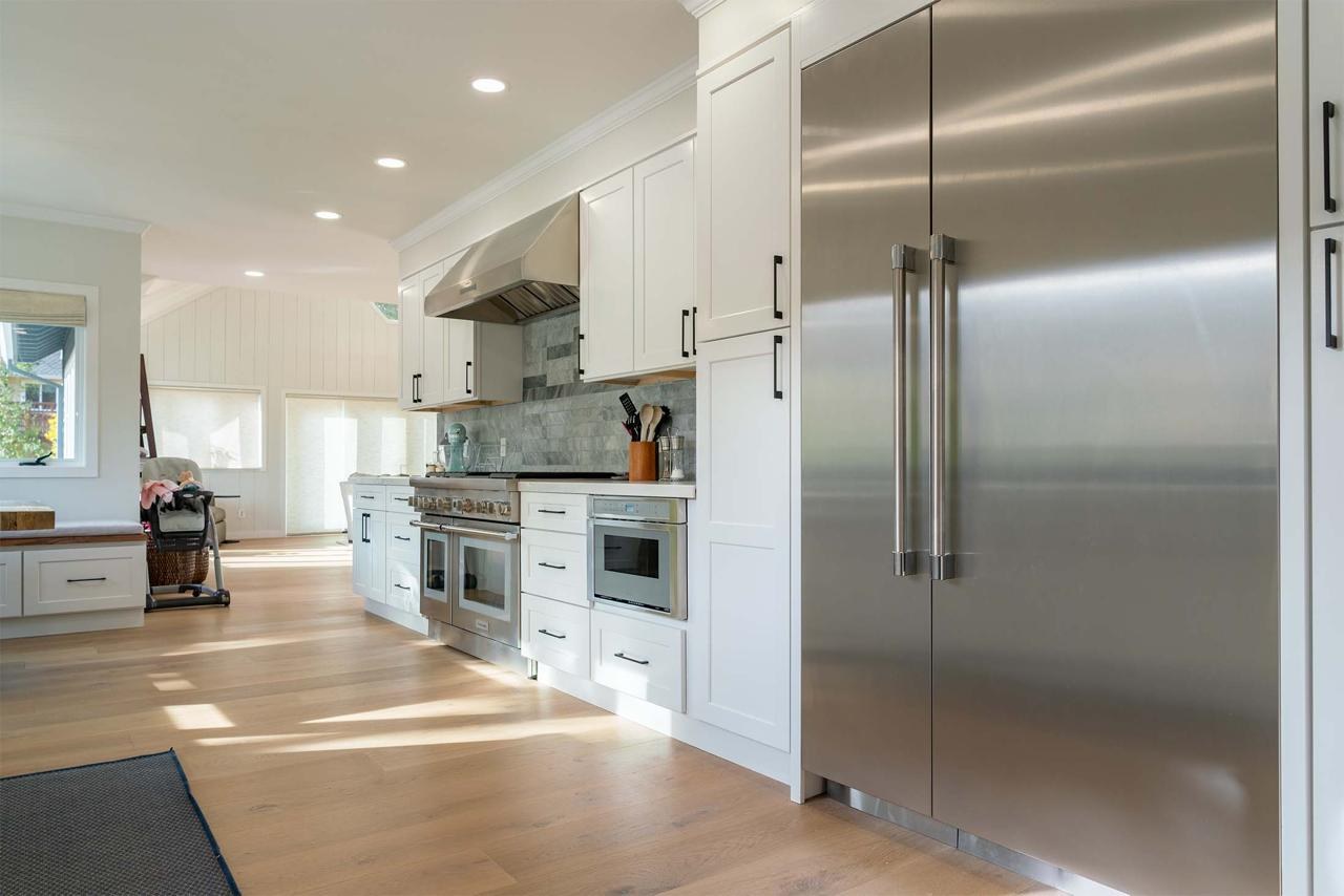 Kitchen remodel featuring custom cabinetry, open layout, engineered white oak hardwood flooring, and modern appliances