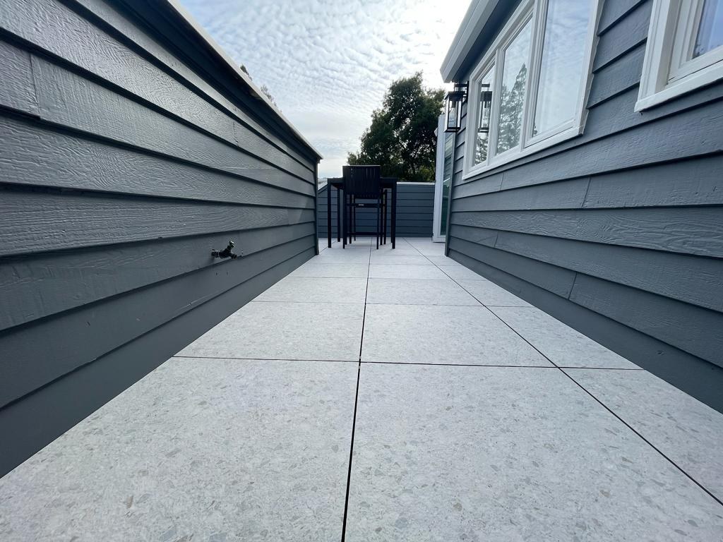 Home remodel showcasing completed balcony with floating tile system and contemporary exterior finishes by ASL Remodeling