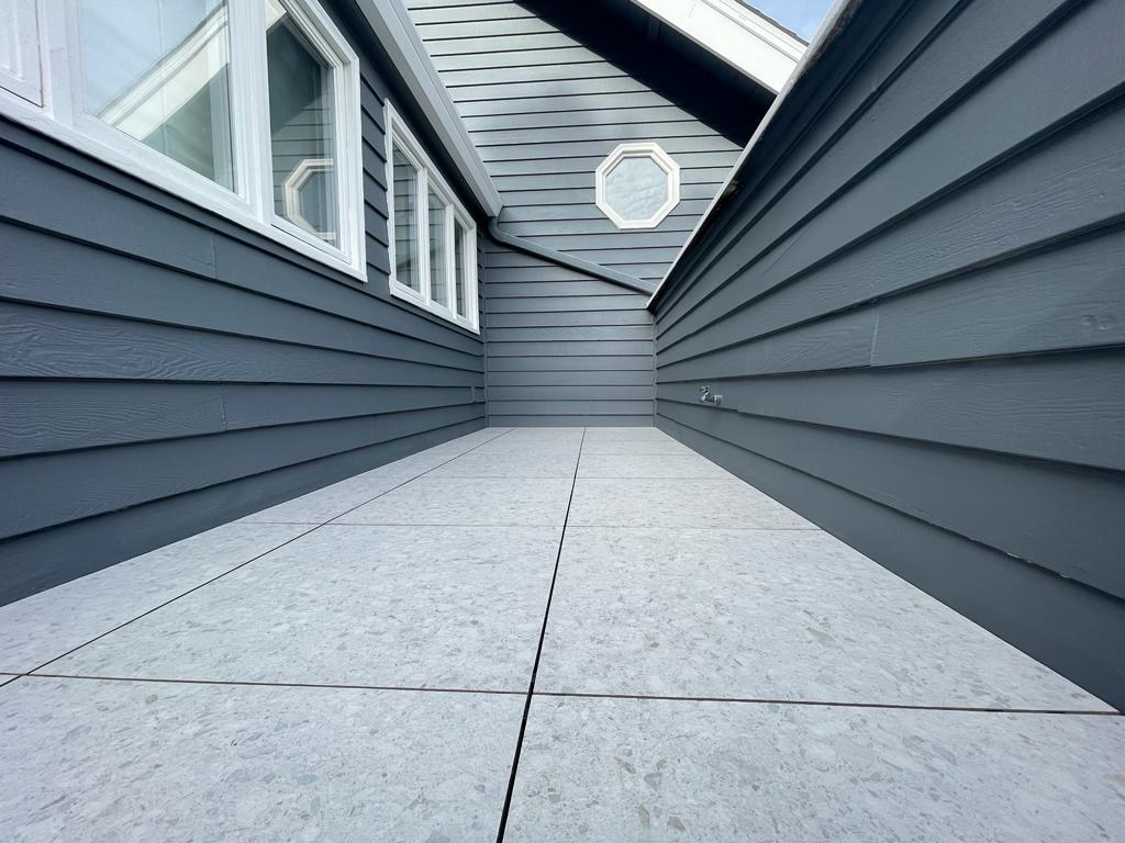 Home remodel featuring balcony resurfacing with floating tile system over CIM 1000 waterproofing membrane for long-term durability by ASL Remodeling