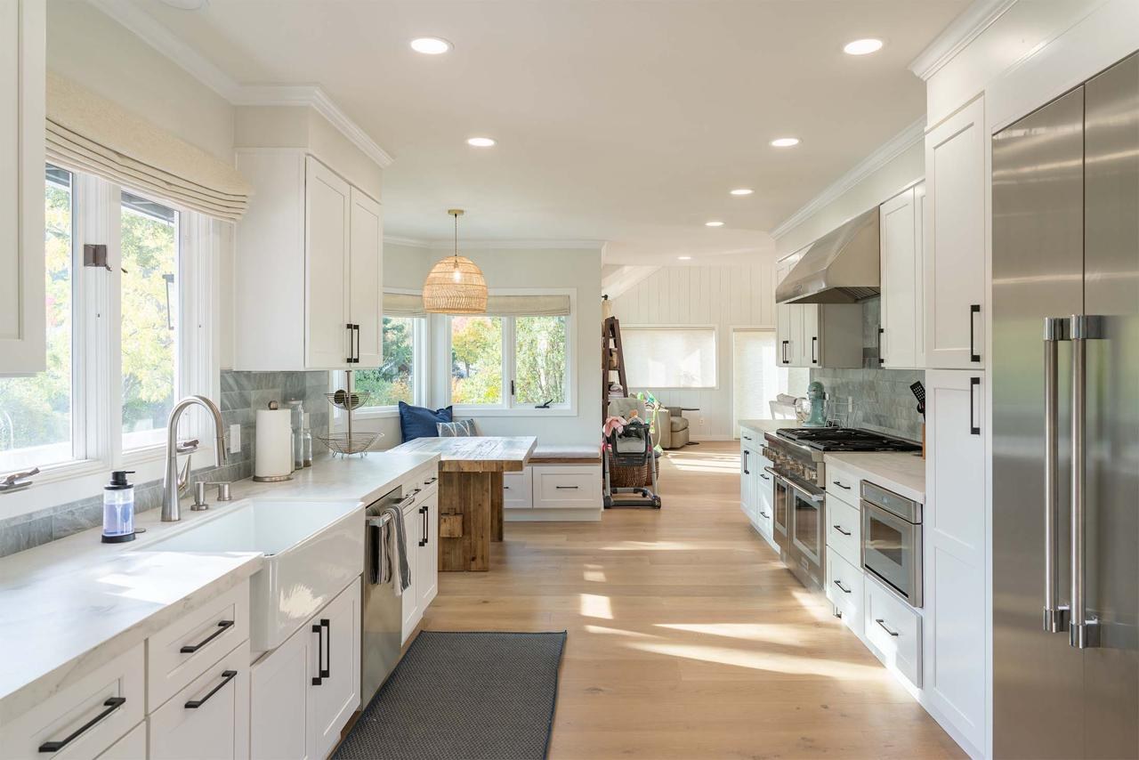 Kitchen with open concept layout, built-in breakfast nook, custom cabinetry, and engineered white oak hardwood flooring